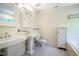 Bathroom with dual sinks, patterned tile floor, and a soaking tub and shower combination at 507 Vatersay Dr, Apex, NC 27502