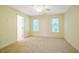 Neutral bedroom showcasing carpeted floors, two sunny windows and painted walls at 507 Vatersay Dr, Apex, NC 27502