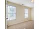 Bedroom showcasing neutral walls, carpeted floors, and two bright windows at 507 Vatersay Dr, Apex, NC 27502