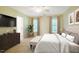 Staged bedroom with a plush bed, tufted bench and dark wood dresser at 507 Vatersay Dr, Apex, NC 27502