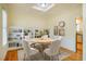 Dining room featuring a round table, four chairs, built-in shelving, and a coffered ceiling at 507 Vatersay Dr, Apex, NC 27502