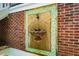 Unique outdoor mosaic tile fountain feature on a brick wall, adding charm to the exterior at 507 Vatersay Dr, Apex, NC 27502