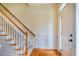 Bright foyer with hardwood floors, staircase with white spindles, and detailed wall trim at 507 Vatersay Dr, Apex, NC 27502