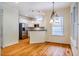 Open-concept kitchen and dining area with modern appliances and hardwood floors at 507 Vatersay Dr, Apex, NC 27502