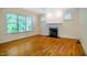 Living room with hardwood floors, large windows and fireplace at 507 Vatersay Dr, Apex, NC 27502