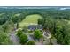 Stunning aerial view of golf course community featuring lush greenery and luxurious clubhouse at 671 Bear Tree Crk, Chapel Hill, NC 27517