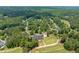 Panoramic aerial view featuring the community, golf course, clubhouse, and lush green trees at 671 Bear Tree Crk, Chapel Hill, NC 27517