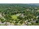 Overhead view of the community amenities, including a pool, tennis courts, and a large grassy area at 671 Bear Tree Crk, Chapel Hill, NC 27517