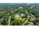A lovely aerial view of the community amenities and a pond in the background, surrounded by lush greenery at 671 Bear Tree Crk, Chapel Hill, NC 27517