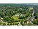 Overhead view of the community amenities, including a pool, tennis courts, and a large grassy area at 671 Bear Tree Crk, Chapel Hill, NC 27517