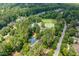 Aerial view of a community featuring a pool, tennis courts, basketball court, and mature trees at 671 Bear Tree Crk, Chapel Hill, NC 27517