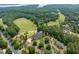 Aerial view of the community, highlighting the golf course, clubhouse, and surrounding wooded areas at 671 Bear Tree Crk, Chapel Hill, NC 27517