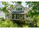 Spacious deck with seating area and potted plants, enhancing the outdoor living space at 671 Bear Tree Crk, Chapel Hill, NC 27517