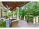 Relaxing back porch area with comfortable seating and a view of the green wooded backyard at 671 Bear Tree Crk, Chapel Hill, NC 27517
