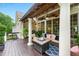 Inviting back porch with outdoor seating, ceiling fan, columns, and view of the backyard at 671 Bear Tree Crk, Chapel Hill, NC 27517
