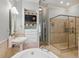 Bright bathroom featuring a glass enclosed shower, built in shelving, and a large soaking tub at 671 Bear Tree Crk, Chapel Hill, NC 27517