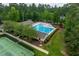 Aerial view of community pool, tennis courts, and playground offering a variety of recreational activities at 671 Bear Tree Crk, Chapel Hill, NC 27517