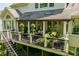 Well-appointed deck featuring ample seating, potted plants, and elegant pillars at 671 Bear Tree Crk, Chapel Hill, NC 27517