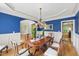 Elegant dining room with blue accent wall, wainscoting, hardwood floors, and decorative chandelier at 671 Bear Tree Crk, Chapel Hill, NC 27517