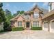 Elegant brick home with a well-manicured lawn, charming front entrance, and an inviting curb appeal at 671 Bear Tree Crk, Chapel Hill, NC 27517