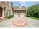 Brick home featuring a two-car garage and decorative brickwork on the driveway at 671 Bear Tree Crk, Chapel Hill, NC 27517