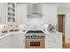 Close-up of a modern kitchen with stainless steel appliances and white cabinetry at 671 Bear Tree Crk, Chapel Hill, NC 27517