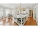 Well-lit kitchen with hardwood floors, island with storage, and adjacent dining area at 671 Bear Tree Crk, Chapel Hill, NC 27517