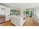 Open kitchen with a large center island, stainless steel appliances, and natural light at 671 Bear Tree Crk, Chapel Hill, NC 27517