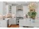 Modern kitchen features white cabinets, stainless steel appliances, and an island with quartz countertops at 671 Bear Tree Crk, Chapel Hill, NC 27517