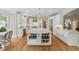 Bright kitchen featuring white cabinets, a large island, and stainless steel appliances at 671 Bear Tree Crk, Chapel Hill, NC 27517