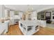 Gourmet kitchen with a large island, modern appliances, and white cabinetry at 671 Bear Tree Crk, Chapel Hill, NC 27517