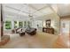 Bright living room featuring a fireplace, large windows, and comfortable seating at 671 Bear Tree Crk, Chapel Hill, NC 27517