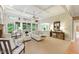 Bright living room with large windows, coffered ceiling, and comfortable seating arrangement at 671 Bear Tree Crk, Chapel Hill, NC 27517