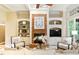 Bright living room with fireplace, built-in shelving and cream-colored furniture at 671 Bear Tree Crk, Chapel Hill, NC 27517