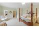 This Main Bedroom features a four-poster bed and wainscoting and is full of natural light at 671 Bear Tree Crk, Chapel Hill, NC 27517