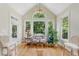 Bright sunroom featuring cathedral ceilings, lots of windows, hardwood floors, and tranquil views of backyard trees at 671 Bear Tree Crk, Chapel Hill, NC 27517
