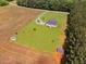 Aerial shot of a farmhouse and acreage with outbuildings and a private drive at 6916 Morrow Mill Road, Chapel Hill, NC 27516