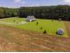 A stunning aerial view of the home set on acres of land and lush greenery at 6916 Morrow Mill Road, Chapel Hill, NC 27516