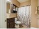 Bathroom featuring a neutral color scheme, vanity, toilet, and a shower with a decorative curtain at 6916 Morrow Mill Road, Chapel Hill, NC 27516