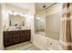 Bathroom featuring dual sinks, a dark brown vanity, and a glass-enclosed shower at 6916 Morrow Mill Road, Chapel Hill, NC 27516