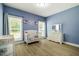 Bedroom features blue walls, natural light, a crib, and a dresser with a mirror at 6916 Morrow Mill Road, Chapel Hill, NC 27516