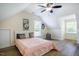 A light-filled bedroom features a comfortable bed, soft decor, and windows with peaceful backyard views at 6916 Morrow Mill Road, Chapel Hill, NC 27516