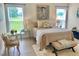 Bright bedroom featuring a large bed, soft rug, and sunny windows with views of the green yard at 6916 Morrow Mill Road, Chapel Hill, NC 27516