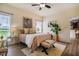 Comfortable bedroom with a ceiling fan and large window to the side at 6916 Morrow Mill Road, Chapel Hill, NC 27516