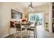 A dining area with pendant lighting, modern decor, an outdoor view, and a dining set for four at 6916 Morrow Mill Road, Chapel Hill, NC 27516