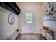 Inviting entryway with coat rack, bench, and decorative accents; view to outside and natural light at 6916 Morrow Mill Road, Chapel Hill, NC 27516