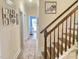 Hallway with staircase, neutral walls, wood floors, and decorative artwork at 6916 Morrow Mill Road, Chapel Hill, NC 27516