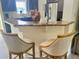 A kitchen featuring granite countertops, stainless steel appliances, and two stylish bar stools at 6916 Morrow Mill Road, Chapel Hill, NC 27516
