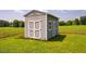 View of a storage shed with painted double doors located next to a field at 6916 Morrow Mill Road, Chapel Hill, NC 27516