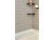 Tiled shower with built-in shelves and white grout for a clean, modern look at 6916 Morrow Mill Road, Chapel Hill, NC 27516